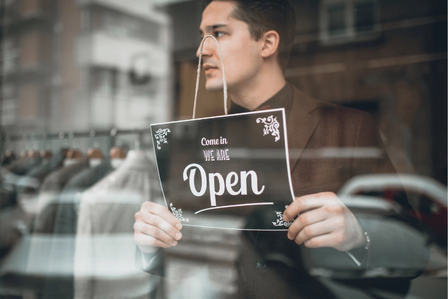 Man opening business with sign