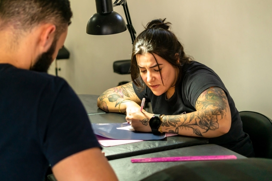 Tattoo artist sketching