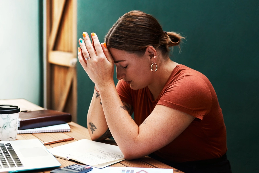 Overwhelmed woman at desk