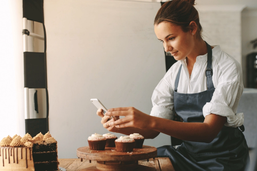 Woman photographing cakes