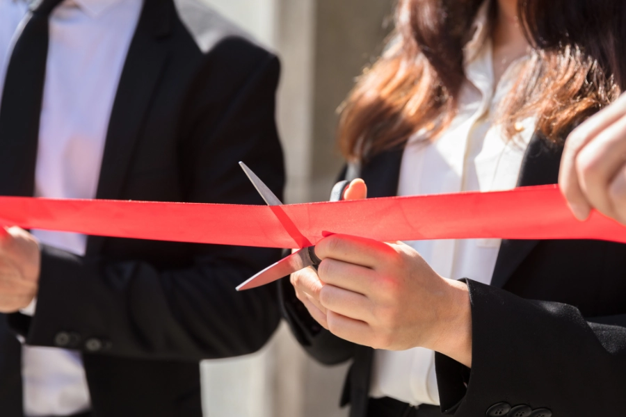 Woman cutting a ribbon